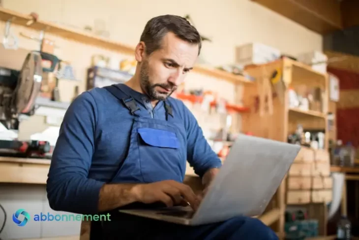 Uomo che lavora al computer nel suo laboratorio, simbolo della gestione di vendite online legate a Mercatino dell’usato e tasse.