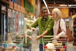 Coppia al supermercato confronta prodotti per risparmiare sulla spesa settimanale